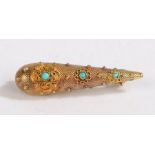 A yellow metal and turquoise tear drop shape brooch. Weighing 3.6 grams. Length 44mm.