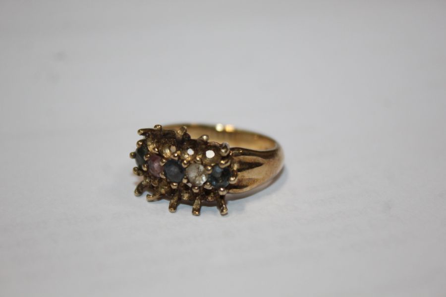 A 9ct gold ring set with five coloured stones. Ring size N. Weighing 4.1 grams.