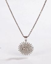 A white metal Indian style sunburst diamond set pendant suspended from a white metal chain.