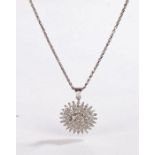 A white metal Indian style sunburst diamond set pendant suspended from a white metal chain.