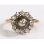 A yellow metal Edwardian grey pearl and diamond set ring. Approx. diameter of pearl 5.50mm. Total