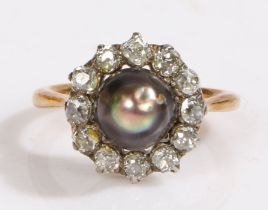 A yellow metal Edwardian grey pearl and diamond set ring. Approx. diameter of pearl 5.50mm. Total