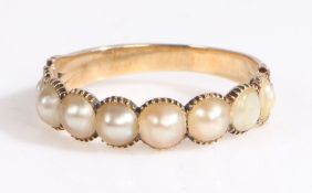 A 9ct yellow gold half eternity ring set with pearls. Ring size O.  Weighing 1.90 grams. Used, in