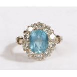 An 18ct white gold aquamarine and diamond cluster ring. Approx. carat weight of aquamarine: 2.10cts.