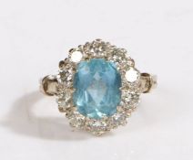 An 18ct white gold aquamarine and diamond cluster ring. Approx. carat weight of aquamarine: 2.10cts.