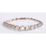 A 9ct rose gold bracelet set with eleven moonstone cabochons in a graduating order. Approx. length