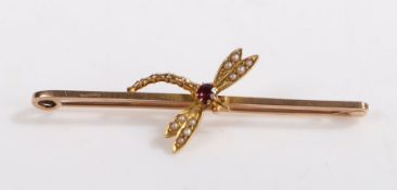 A 9ct yellow gold dragonfly brooch, with garnets for the body and pearls for the wings. Length 54mm.