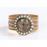 An 18th century yellow metal mourning keepsake ring.  Woven hair in a circular casing with