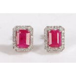 A pair of 18ct white gold ruby and diamond cluster earrings. Approx. measurements of rubies: 7 x