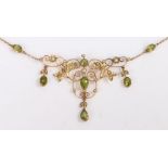 A vintage 9ct yellow gold peridot and seed pearl floral necklet. Approx. length 43cm. Weighing 7.