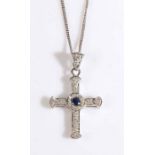 An 18ct white gold crucifix pendant set with one sapphire and diamonds suspended from an 18ct