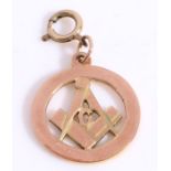 A 9ct yellow gold round Masonic geometry pendant/charm with a compass, ruler and letter G.