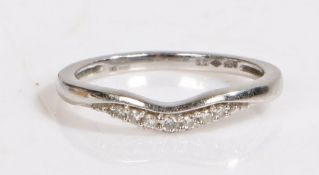 A platinum curved wedding band set with diamonds. Approx. total diamond carat weight: 0.05cts.