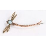 A 9ct yellow gold dragonfly brooch. With aquamarines set to the body and pearl set eyes. Length