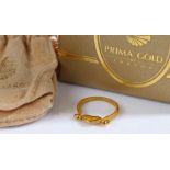 A 24ct yellow gold swivel heart ring by PrimaGold. With paperwork and a bag from PrimaGold. Ring