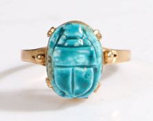 A 9ct yellow metal carved blue scarab beetle ring.  Approx. 13.5 x 10mm. Ring size P. Weighing 2.