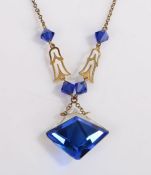 A yellow metal art deco necklace with a faceted clear and blue paste pendant. Weighing 5.50 grams.