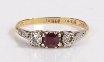 An 18ct yellow and white gold ruby and diamond trilogy ring. Approx. carat weight of ruby: 0.