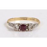 An 18ct yellow and white gold ruby and diamond trilogy ring. Approx. carat weight of ruby: 0.