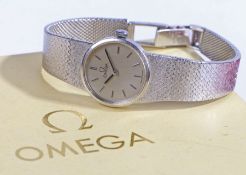 Omega 9 carat white gold ladies wristwatch, circa 1977, the signed silver dial with baton markers,
