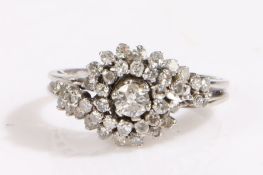 An 18ct white gold diamond halo ring. One central round cut diamond, approx. carat weight 0.