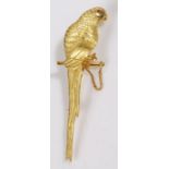 An 18ct yellow gold parrot brooch with a round ruby for an eye. Length 63mm. Weighing 8.40 grams.