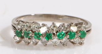 An emerald and diamond cluster ring. Approx. total emerald carat weight: 0.20cts. Approx. total