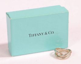 A sterling silver Tiffany & Co. three band interlocking ring, with bag and box. Ring size H.