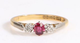 An 18ct yellow gold and platinum trilogy ring set with one ruby and two diamonds. Approx. ruby carat