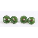 A pair of yellow metal round jade cuff-links set with a ruby in each. Approx. total ruby carat