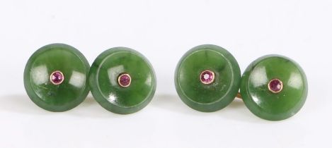A pair of yellow metal round jade cuff-links set with a ruby in each. Approx. total ruby carat