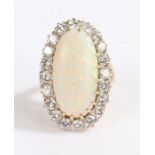 An 18ct yellow and white gold opal and diamond cluster ring. Approx. opal carat weight: 8.45cts.