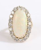 An 18ct yellow and white gold opal and diamond cluster ring. Approx. opal carat weight: 8.45cts.