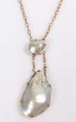 A 9ct gold necklace with two mothers of pearls on a pendant. Approx. length 25cm. Weighing 5.3