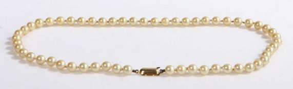 An individually knotted creamy yellow pearl necklace with a 9ct yellow gold clasp.  Length 41cm.
