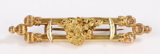 An 18ct yellow gold double bar brooch with an Australian gold nugget. Central nugget tested as