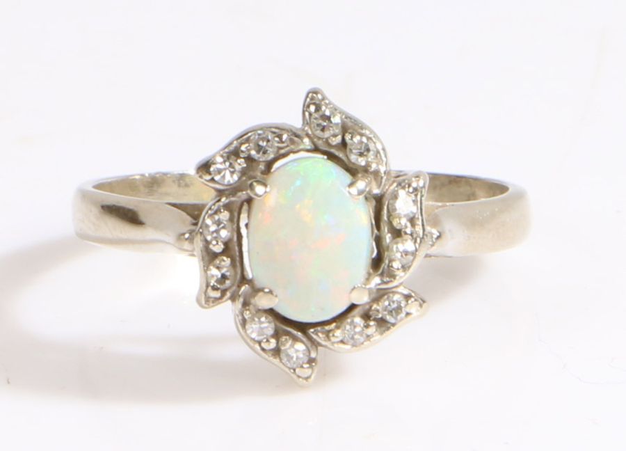 A 14ct white gold opal and diamond cluster ring. Approx. total diamond carat weight: 0.12cts.