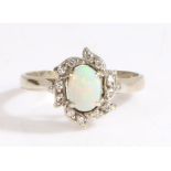 A 14ct white gold opal and diamond cluster ring. Approx. total diamond carat weight: 0.12cts.