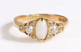 An 18ct yellow gold ring with an opal and diamonds. Approx. oval measurements: 7.4 x 3.7mm.