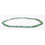 A graduated jade necklace with individually knotted pebble shaped beads. Approx. length 84cm.