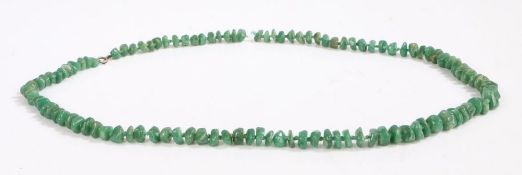 A graduated jade necklace with individually knotted pebble shaped beads. Approx. length 84cm.