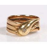 A 9ct yellow gold coiled snake ring with one diamond. Approx. diamond carat weight 0.07cts.