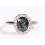 A white metal alexandrite and diamond cluster ring. Approx. carat weight: 1.20cts. Clarity: Eye