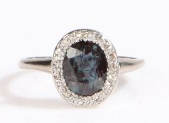 A white metal alexandrite and diamond cluster ring. Approx. carat weight: 1.20cts. Clarity: Eye