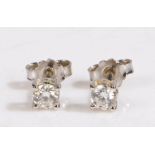 A pair of 18ct white gold solitaire diamond stud earrings. Total approx. diamond carat weight 0.