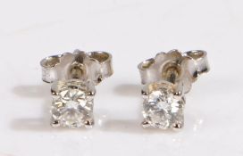 A pair of 18ct white gold solitaire diamond stud earrings. Total approx. diamond carat weight 0.