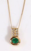 An 18ct yellow gold emerald and diamond set pendant suspended from an 18ct yellow gold chain.
