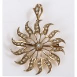 A 9ct yellow gold star/sun shaped pendant and brooch, set with round pearls. Diameter 29mm. Weighing