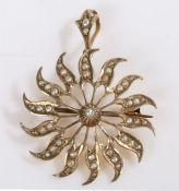A 9ct yellow gold star/sun shaped pendant and brooch, set with round pearls. Diameter 29mm. Weighing