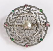 A silver 'suffragette' brooch with a mother of pearl and leaf surround with stones to the edges.
